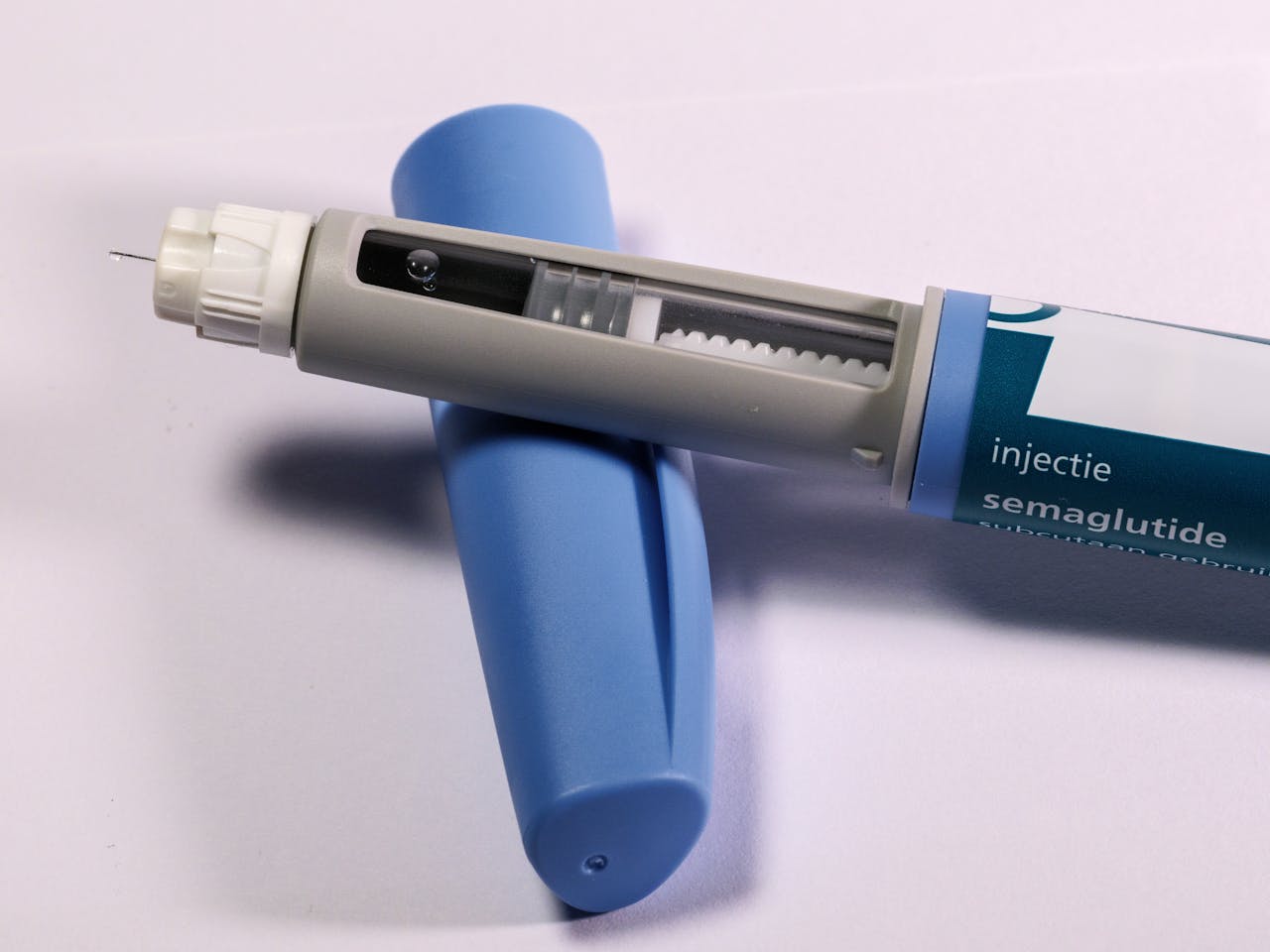 contact-img Detailed view of a semaglutide injection pen, commonly used for diabetes treatment, on a plain background.